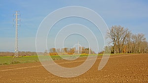 Electricity poles and wires though an autum farm landscape in the Flemish Ardennes photo