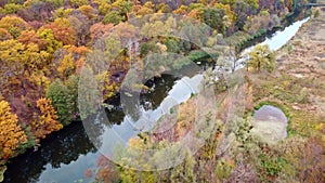 Autumn aerial arc flight on river in yellow forest