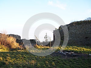 Autumn afternoon in the woods near the ruins of an old stone castle, sunny cold day, wild nature, adventure trip, travel