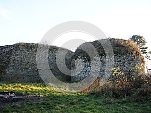 Autumn afternoon in the woods near the ruins of an old stone castle, sunny cold day, wild nature, adventure trip, travel