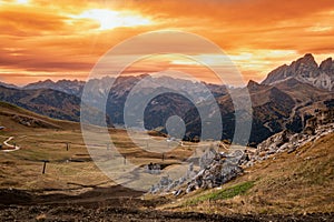 Autumn alpine Dolomites mountain dramatic sunset scene near Pordoi Pass, Trentino , Italy