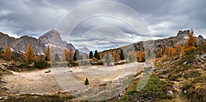 Autumn alpine Dolomites mountain scene, Italy. Dried up Limides Lake near Falzarego Pass