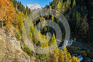 Autumn alpine Dolomites mountain view with small waterfall, Sudtirol, Italy