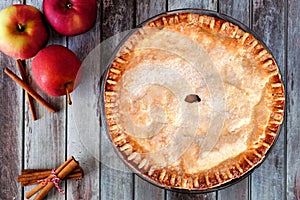 Autumn apple pie, overhead table scene over rustic wood