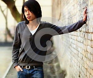 Autumn Asian man and brick wal