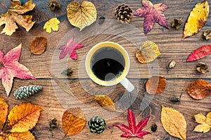 Autumn Background with Autumn Leaves on Oak Wood with Mug of Coffee