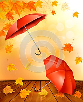 Autumn background with autumn leaves and orange umbrellas.