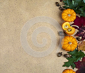 Autumn background with autumn leaves and pumpkins, space for text.