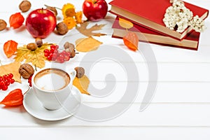 Autumn background, cup of cappuccino, books, space for text.