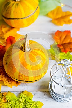 autumn background with pumpkins and leaves and candle