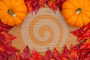 Autumn background with a pumpkins and red and orange fall leaves