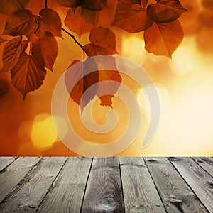 Autumn Background with Red Linden Leaves and Abstract Bokeh Glitter with empty dark wooden board background