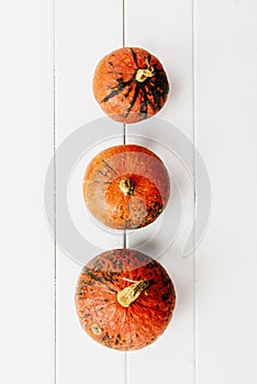 Autumn background with three pumpkins