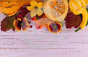 Autumn background to Thanksgiving Day, pumpkins, leaves, flowers on a white wood background. Copy space.