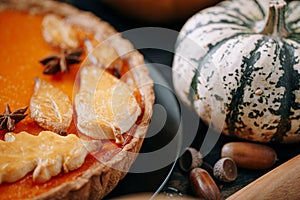 Autumn baking background with pumpkin pie pumpkin yellow autumn leaves on wooden background