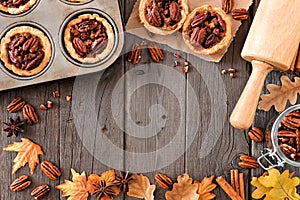 Autumn baking scene frame with pecan tarts over wood