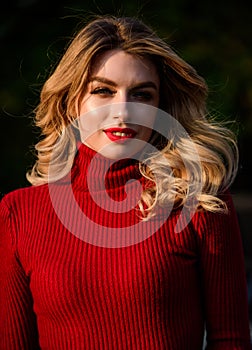 Autumn beauty. haidresser and makeup. fall fashion season. girl long blond hair. girl red lipstick in knitwear sweater