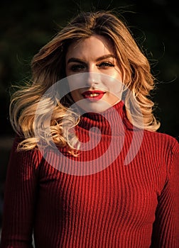 Autumn beauty. haidresser and makeup. fall fashion season. girl long blond hair. girl red lipstick in knitwear sweater