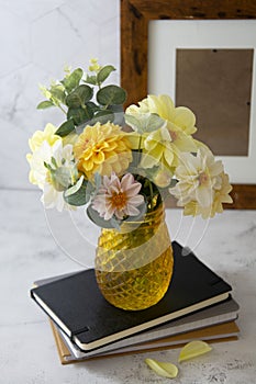 Autumn bouquet with fresh dahlia flowers, notebooks, work space