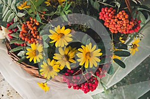 Autumn bouquet with garden flowers and branches of mountain ash.