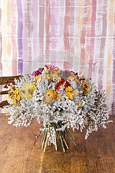 Autumn bouquet with proteas, chrysanthemums and hawthorn twigs.