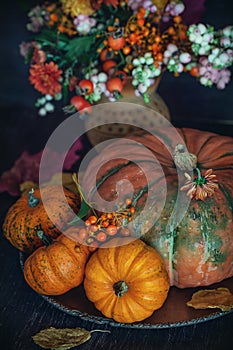 Autumn bouquet with a pumpkin on the table.