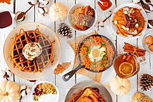 Autumn breakfast or brunch buffet table scene against a white wood background. Top view. photo