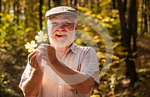 Autumn brings much joy. Happy pensioner collect autumn leaves in wood. Aged person happy smiling on autumnal landscape