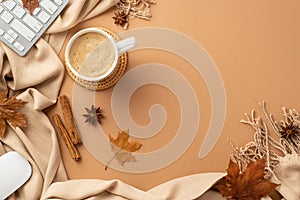 Autumn business concept. Top view photo of cup of frothy cocoa on rattan serving mat computer mouse keyboard yellow maple leaves