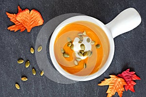 Autumn butternut squash soup on slate background