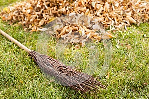 Autumn clearing - besom and a pile of leaves