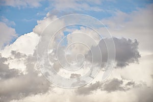 Autumn cloudy sky. Cold gray and white clouds on a background of blue sky.