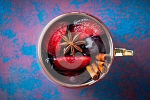Autumn cocktail in copper mug with red plums