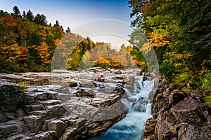 Autumn color and waterfall at Rocky Gorge, on the Kancamagus Highway, in White Mountain National Forest, New Hampshire.