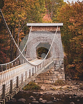 Autumn color and the wire bridge in New Portland, Maine