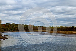 Autumn colored water view of sunset  picturesque nature with  river and yellowed  trees in the  .    landscape. Soft filter