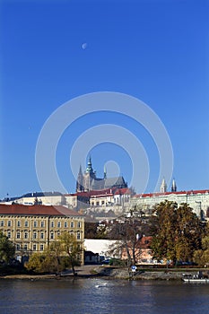 Autumn colorful Prague Lesser Town with gothic Castle above River Vltava in the sunny Day, Czech Republic