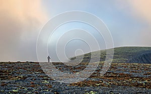 Autumn colorful tundra on the background mountain peaks in cloudy weather. Mountain landscape in Kola Peninsula, Arctic