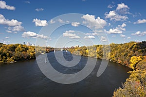 Autumn colors along the Mississippi River, Minneapolis skyline in the distance.