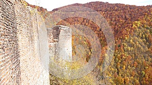 Autumn colours - colorful leafage of the mountain forests next to Poenari citadel ruin walls