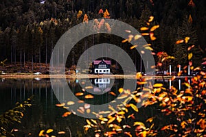 Autumn colours of Lake Toblacher See, Lago di Dobbiaco in Dolomites Italy