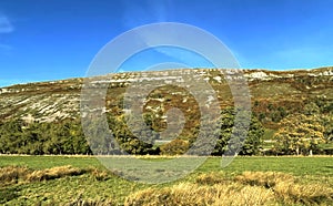 Autumn colours in, Littondale, with sloping fells, and a blue sky near, Hawkswick, Yorkshire, UK