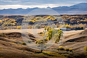 Autumn colours overlooking the East Slopes of the Canadian Rocky Mountains and a working cattle ranch near