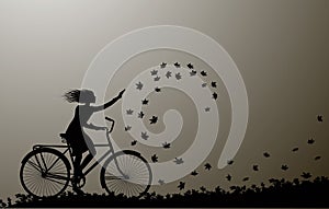 Autumn come, girl riding on the bicycle and autumn leaves swirling, silhouette, black and white,