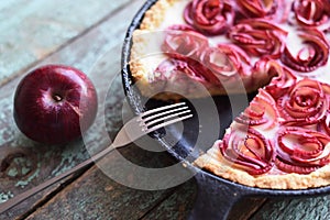 Autumn comfort food. Homemade pie with apple roses in cast iron