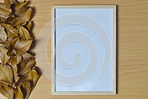 Autumn composition concept. Blank frame with pencil and autumn leaves on white background