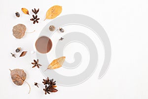 Autumn composition. Cup of coffee, autumn leaves on white wooden background. Flat lay, top view copy space