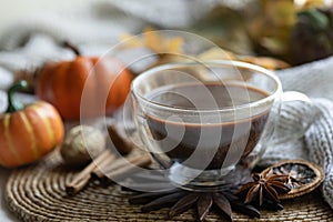 Autumn composition with a cup of hot drink close-up.