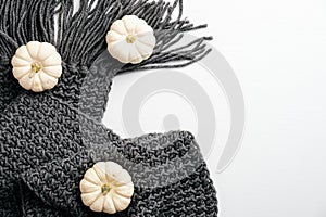 Autumn composition. Feminine desk table with knitted scarf, pumpkins on white background. Flat lay, top view. Nordic, hygge, cozy