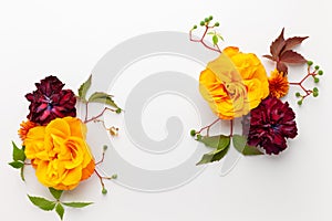 Autumn composition with flowers, leaves and berries on white background. Flat lay, copy space